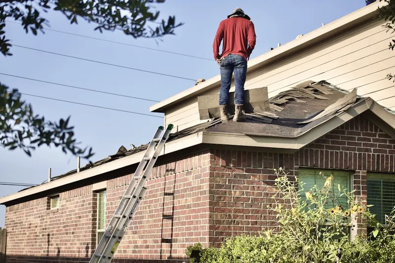 Professional roofer working on a residential roof in Wilbanks Corner